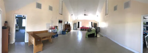 a hallway with wooden floor and furniture