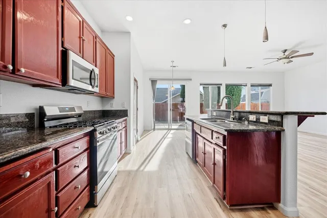 a kitchen with stainless steel appliances granite countertop a stove and a sink