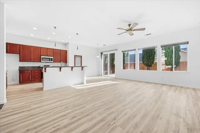 a view of a kitchen with wooden floor and a kitchen