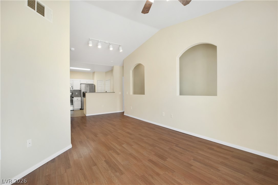 10550 West Alexander Road, Unit 2171 Las Vegas, NV 89129 - Photo 5 of 17 Vaulted ceilings and warm wood-look floors define this inviting open living space.