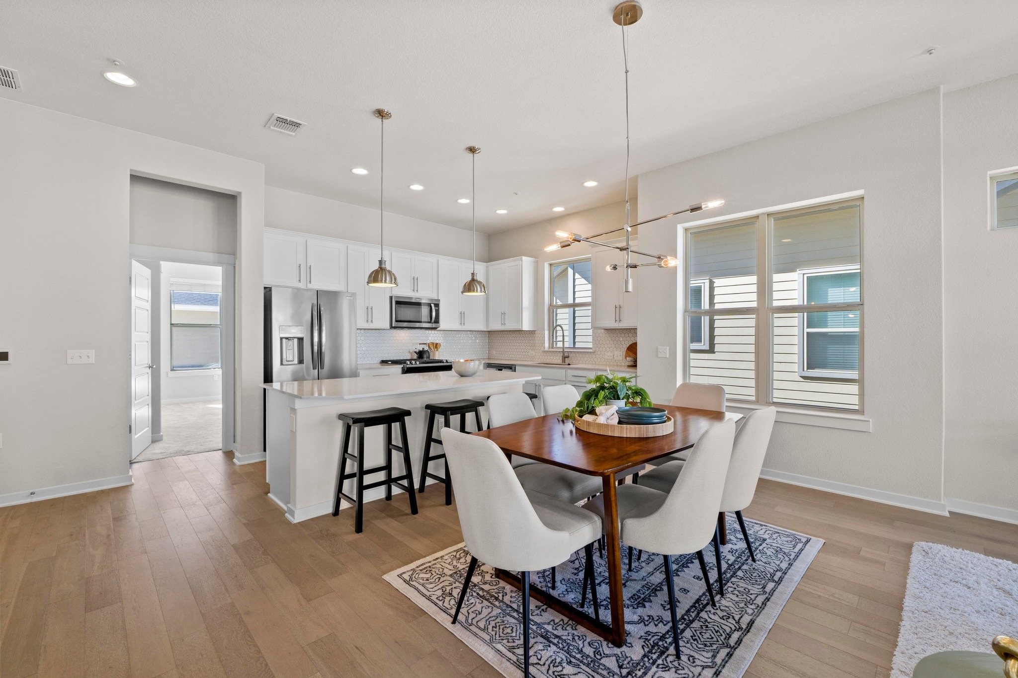 4617 Herzog Street Austin, TX 78723 - Photo 18 of 38 a dining room with stainless steel appliances kitchen island granite countertop furniture wooden floor and a rug