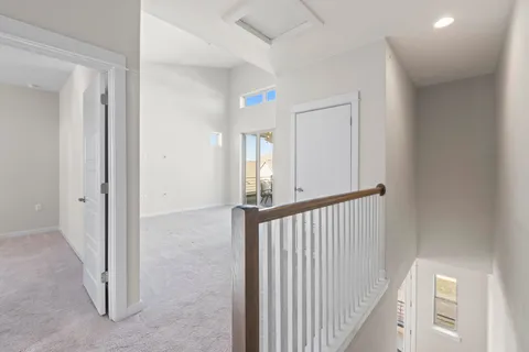 a view of a hallway with entryway door