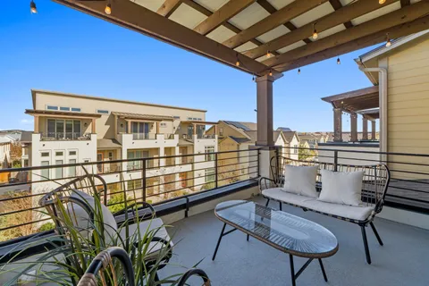 a view of a chairs and table in patio