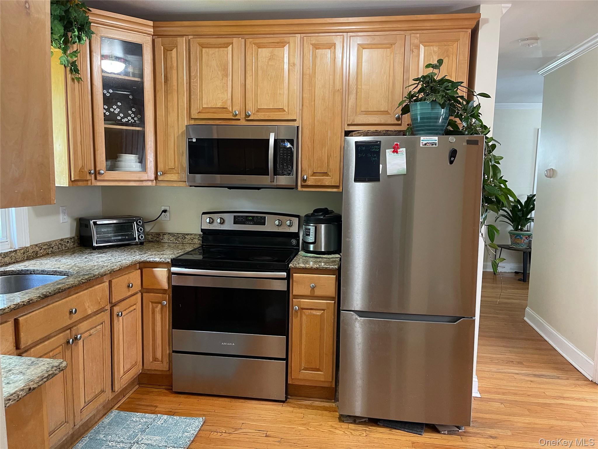 73 South Bedford Road Chappaqua, NY 10514 - Photo 14 of 30 a kitchen with stainless steel appliances a refrigerator stove and microwave