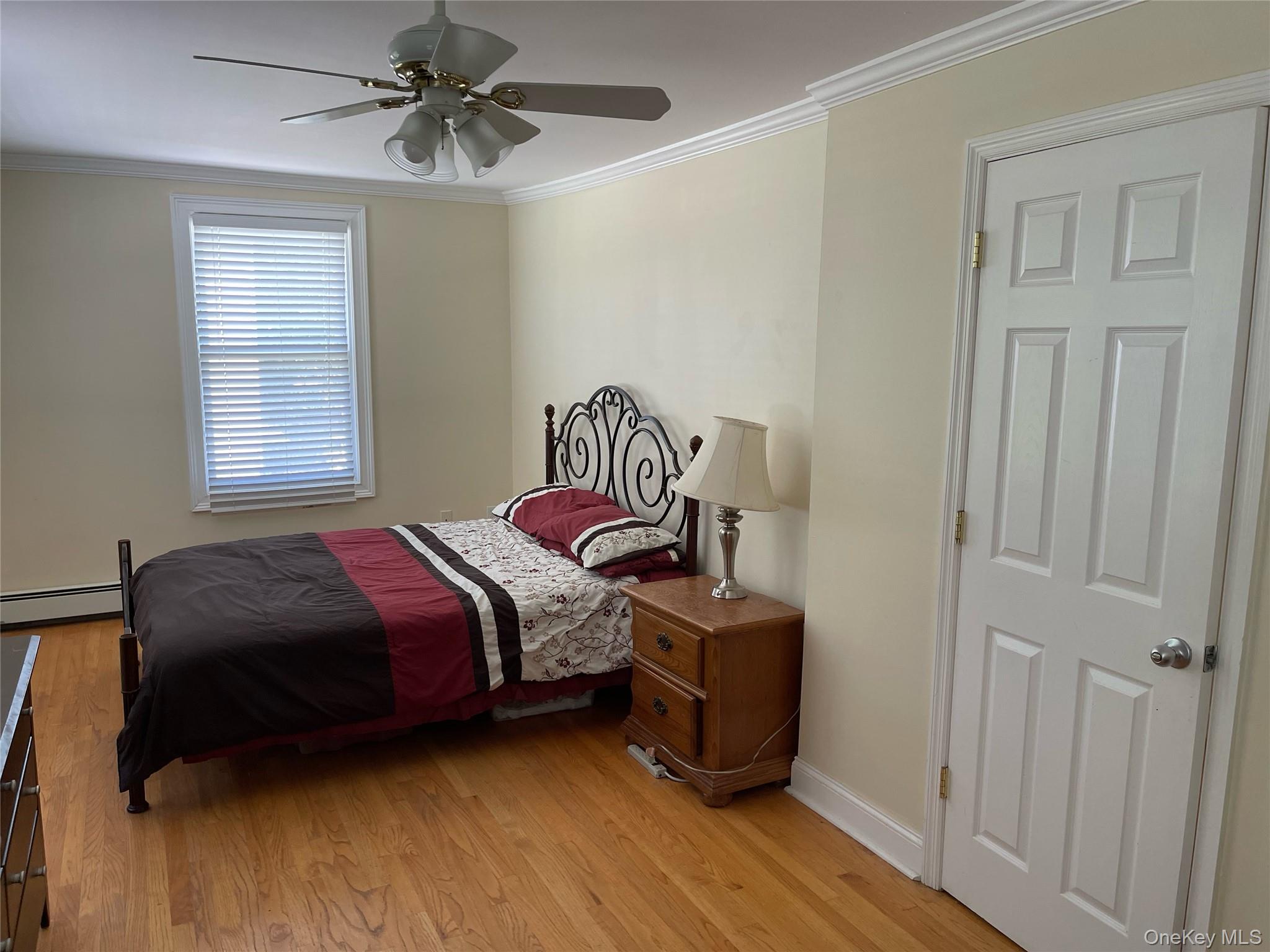 73 South Bedford Road Chappaqua, NY 10514 - Photo 22 of 30 a bedroom with a bed a dresser and potted plants on the wooden floor