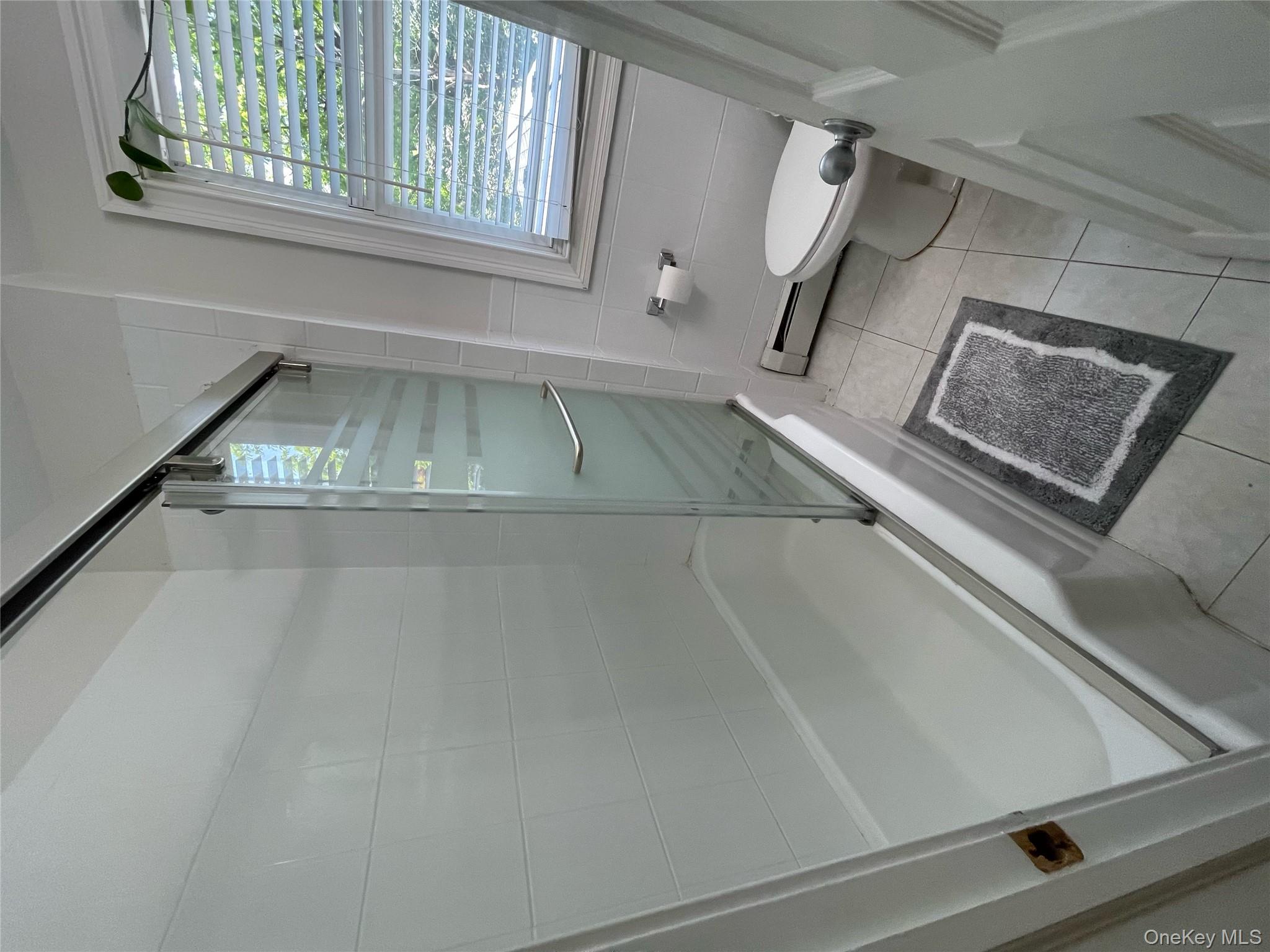 73 South Bedford Road Chappaqua, NY 10514 - Photo 27 of 30 a bathroom with a tub and a shower