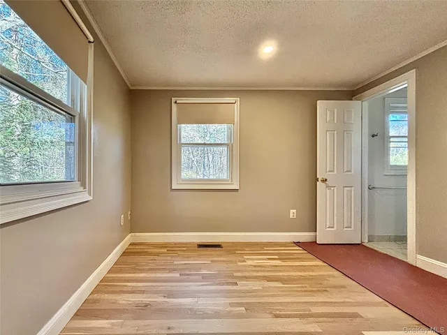 a view of a livingroom with wooden floor and a window