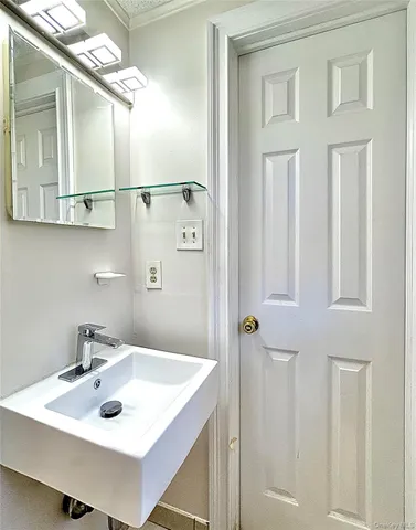 a bathroom with a sink and mirror