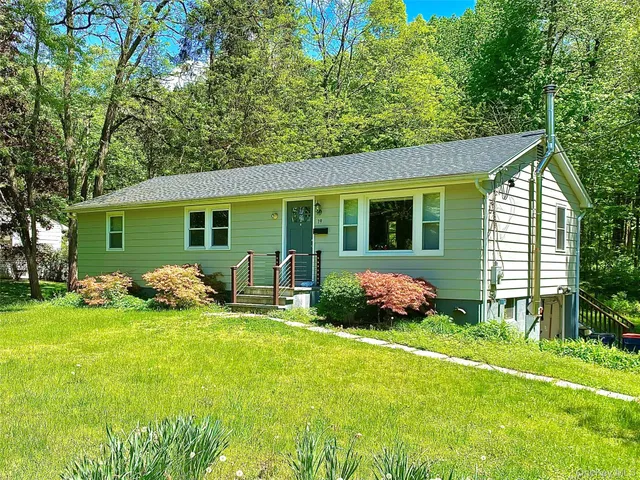 a front view of house with yard and green space