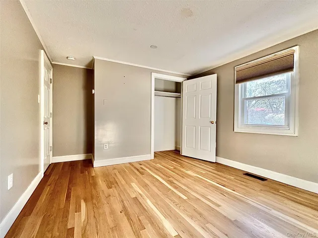 a view of a room with wooden floor and a ceiling fan