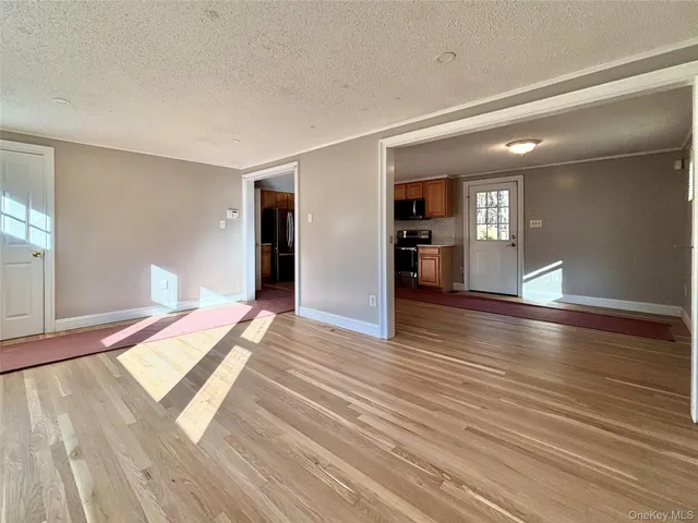 a view of a room with wooden floor and stairs