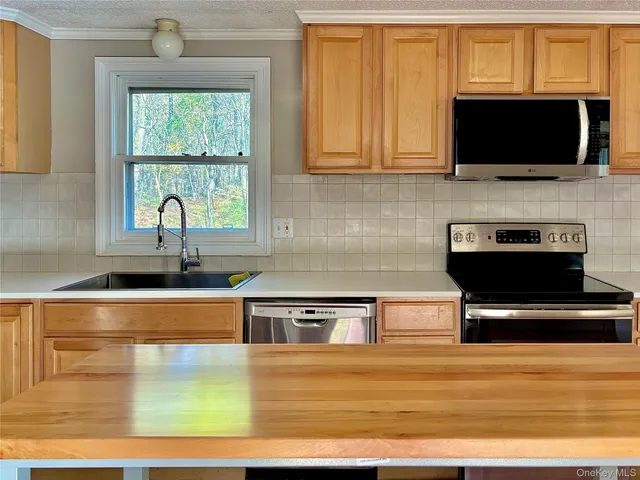 a kitchen with a sink and a microwave