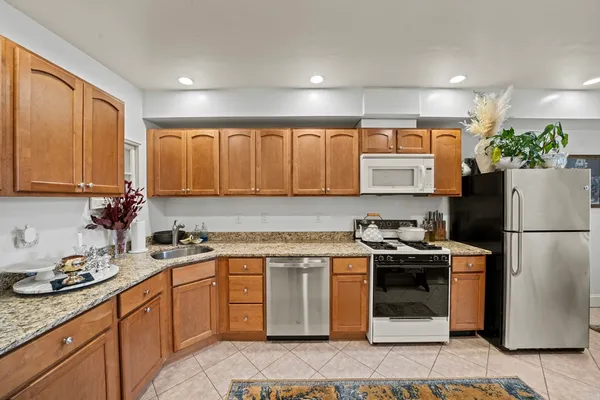a kitchen with a sink stove and refrigerator