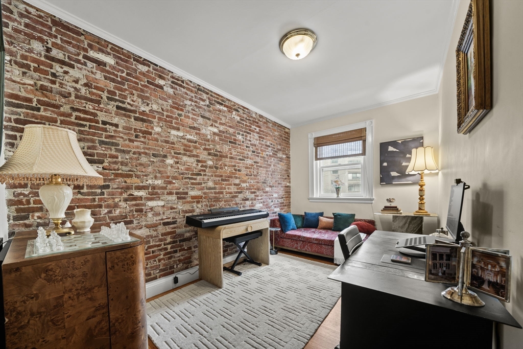 9 Regent Circle, Unit 3 Brookline, MA 02445 - Photo 9 of 20 a living room with furniture a fireplace and a flat screen tv