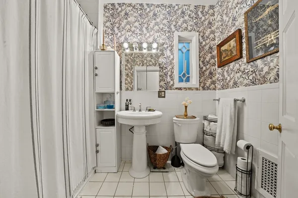 a white toilet sitting next to a bathroom sink