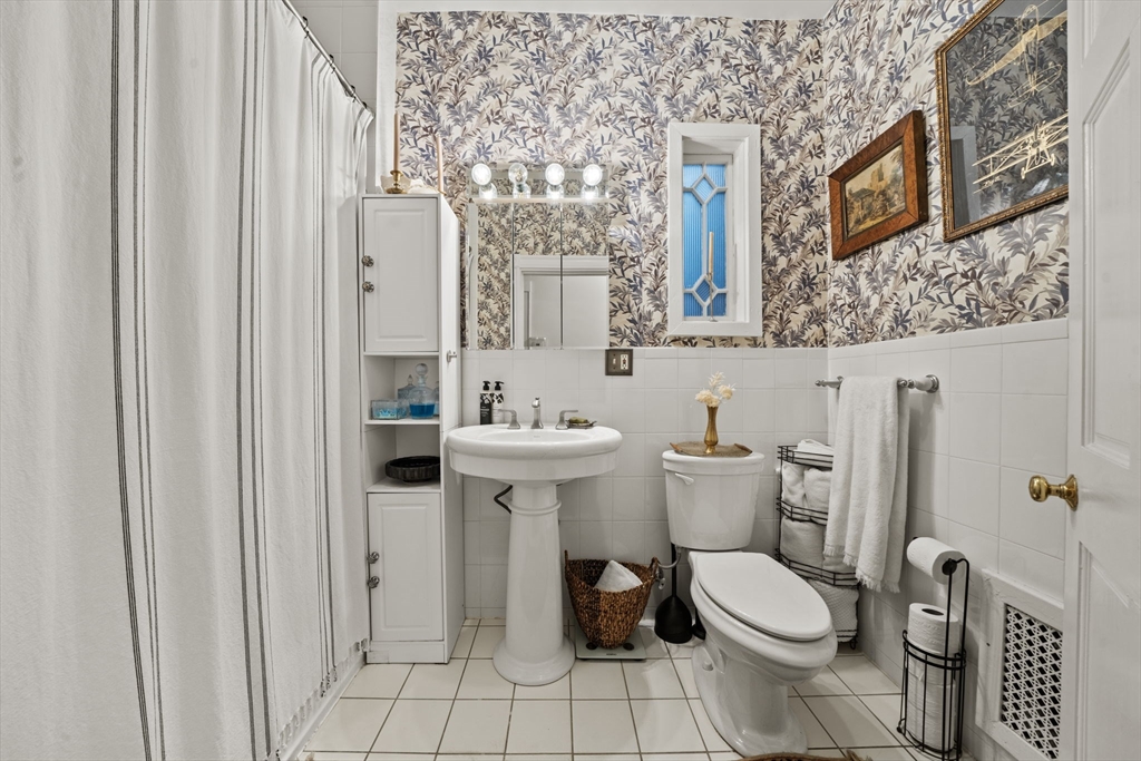 9 Regent Circle, Unit 3 Brookline, MA 02445 - Photo 10 of 20 a white toilet sitting next to a bathroom sink