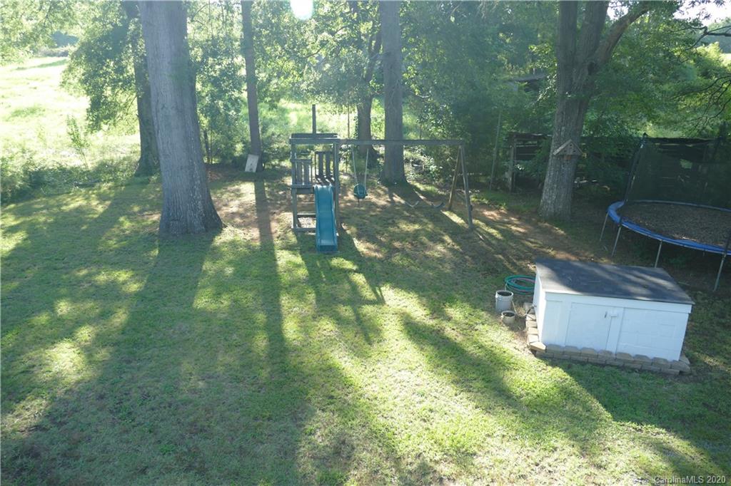 5901 Cress Road Concord, NC 28025 - Photo 22 of 27 a backyard of a house with lots of green space