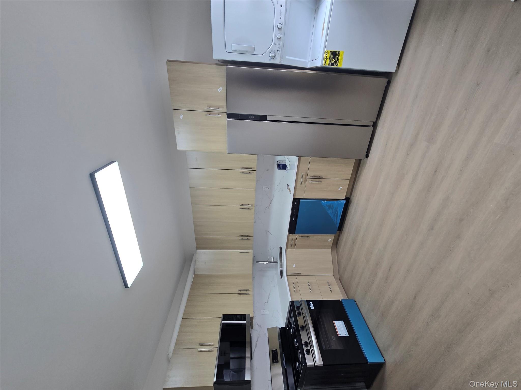 a kitchen with stainless steel appliances granite countertop a refrigerator and a stove