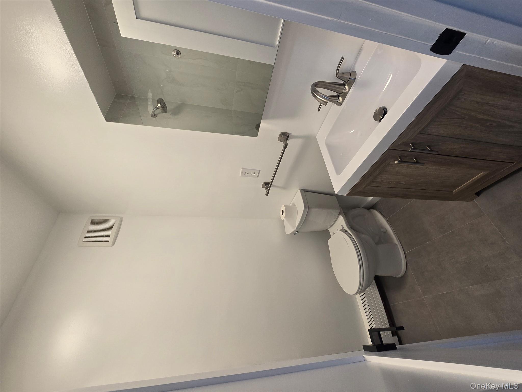 112 Webster Avenue, Unit 3 New Rochelle, NY 10801 - Photo 5 of 7 a bathroom with a sink toilet and mirror