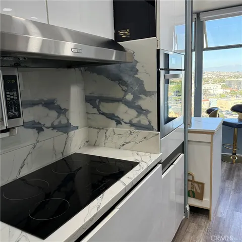 a kitchen with a sink and a stove next to a window
