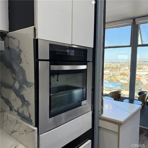 a kitchen with kitchen island a sink a refrigerator and cabinets