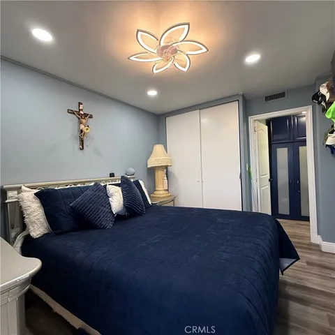 a bedroom with furniture and a flat screen tv