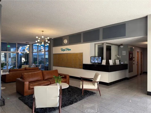 a view of a patio with couches table and chairs with wooden floor and fence