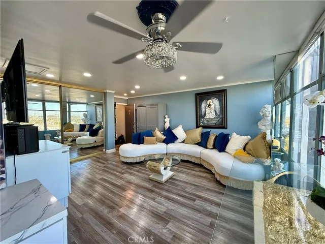 a living room with furniture and a chandelier