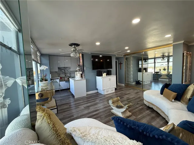 a living room with furniture and kitchen view