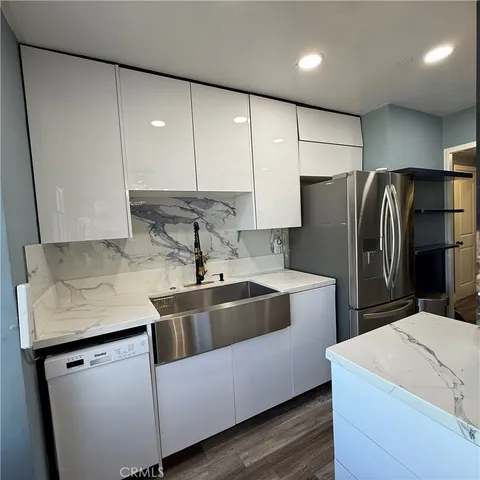 a kitchen with refrigerator and cabinets