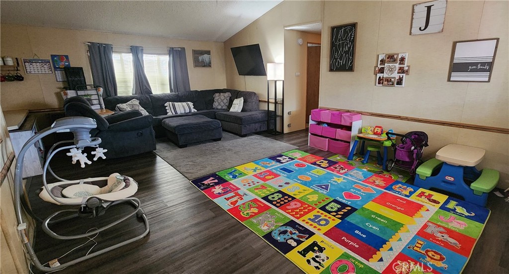 3589 West Wells Road, Unit 99 Blythe, CA 92225 - Photo 2 of 27 a bedroom with furniture and a wooden floor
