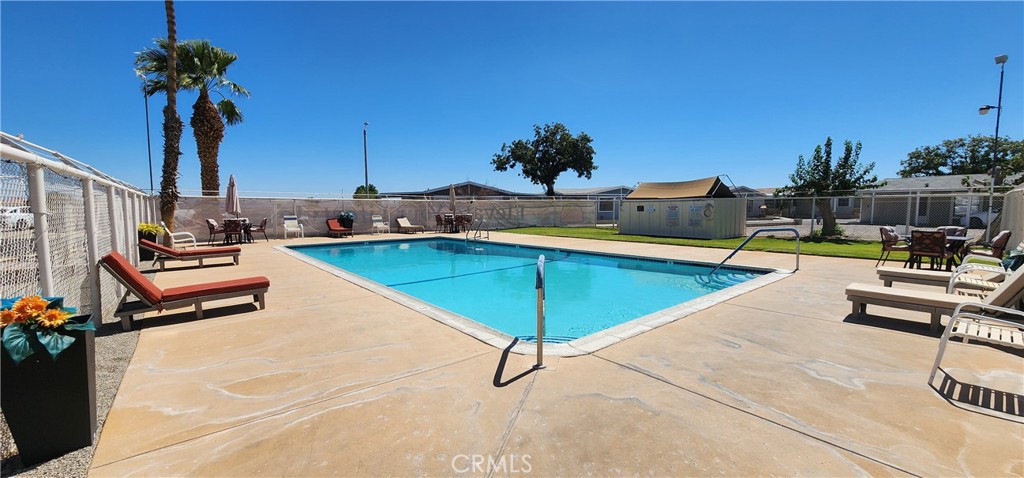 3589 West Wells Road, Unit 99 Blythe, CA 92225 - Photo 24 of 27 a view of a swimming pool with lounge chairs