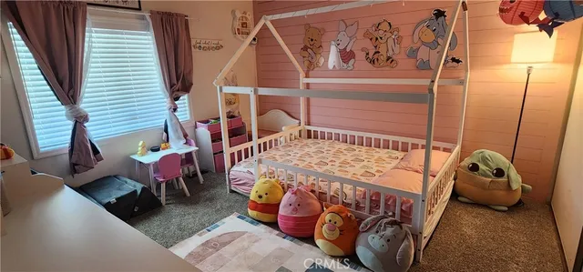 a bedroom with bed and a window