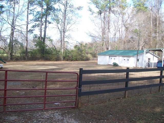 168 Liberty Ridge Drive Gray, GA 31032 - Photo 14 of 22 a view of backyard with wooden fence and a large tree