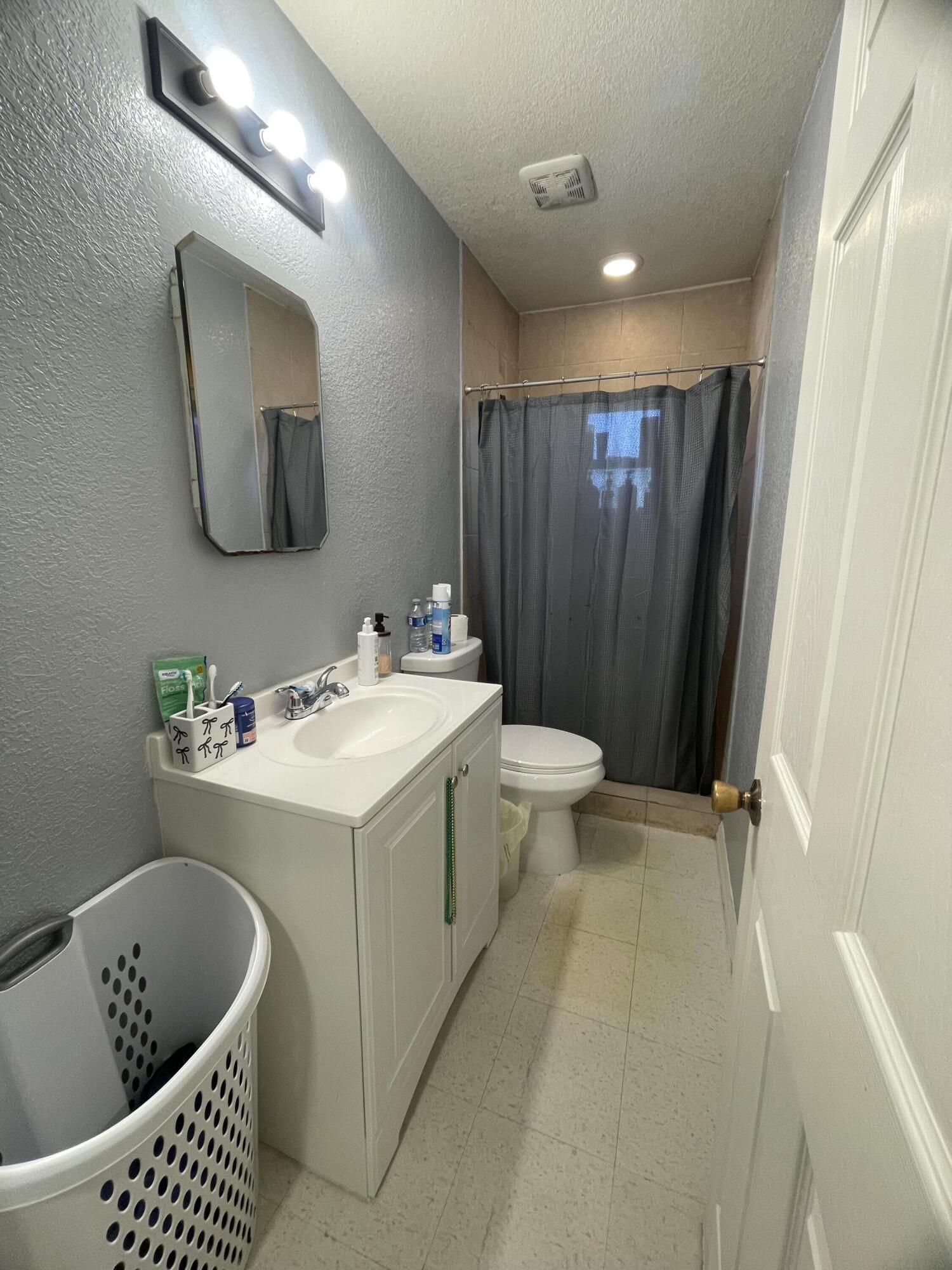 1220 A Road LaBelle, FL 33935 - Photo 23 of 42 a bathroom with a sink a toilet and mirror