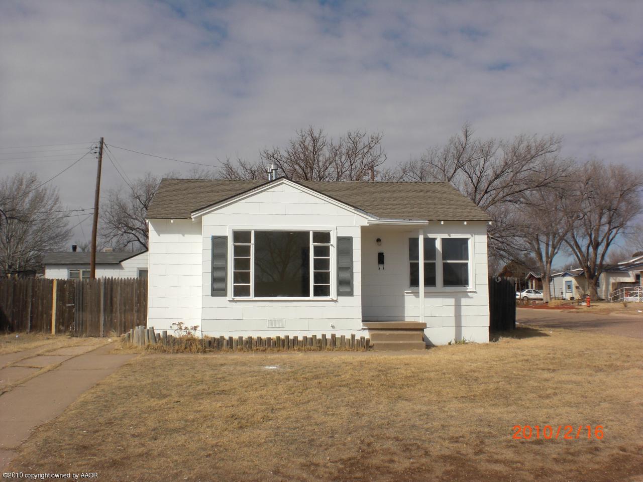1600 Southwest 48th Avenue Amarillo, TX 79110 - Photo 1 of 1 a front view of a house with a yard and garage