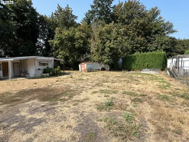 a white house covered with snow in front of house