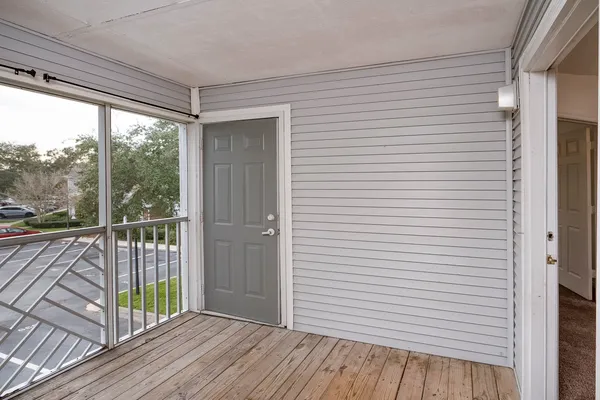 a view of a balcony with wooden floor