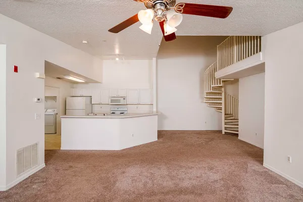 a view of kitchen and refrigerator