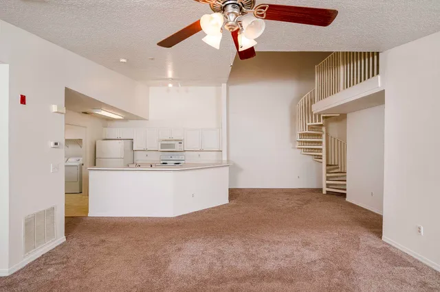 a view of kitchen and refrigerator