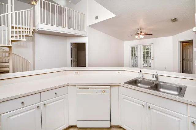 a kitchen with a sink and cabinets