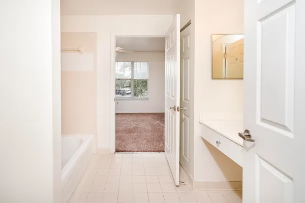 a bathroom with a tub and mirror