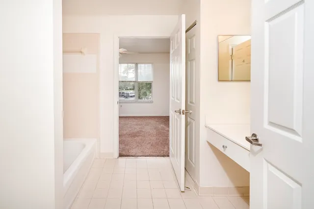 a bathroom with a tub and mirror