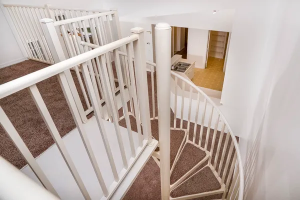 a view of stairs and an entryway with wooden floor