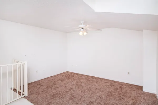 an empty room with a ceiling fan and a ceiling fan