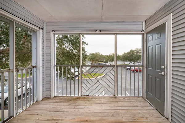 a view of a balcony with wooden floor