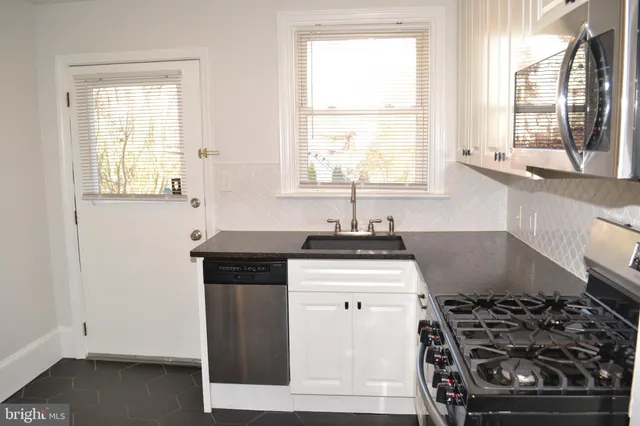 a kitchen with a stove and a window