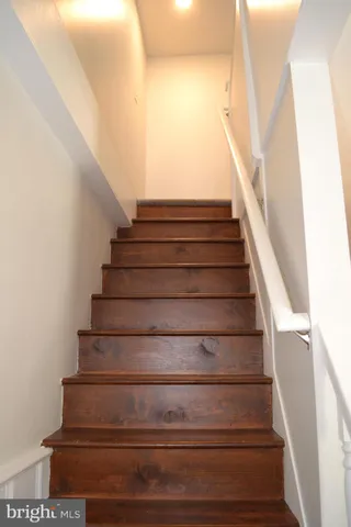 a living room with a fireplace and wooden floor