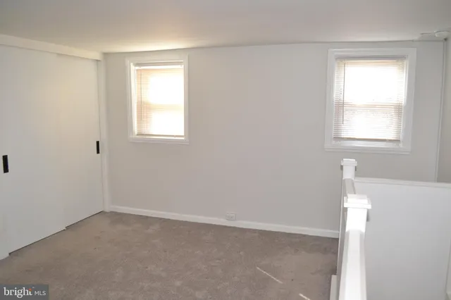 a view of an empty room with white walls