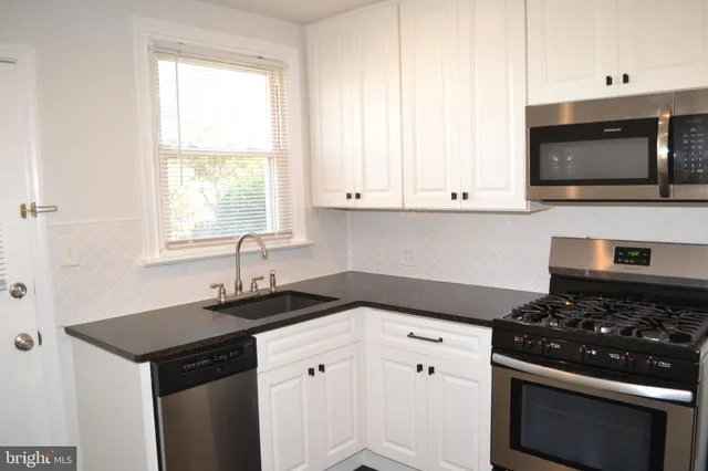 a kitchen with a stove and a window